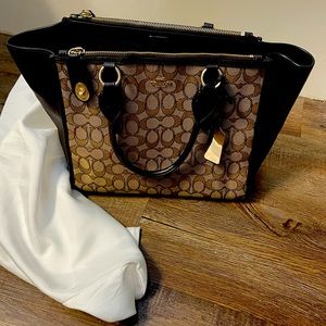 Coach handbag with Coach C insignia.